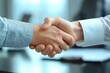 © alsu0112 - Close-up of people shaking hands over an office desk with documents on it, with emphasis on the handshakes. Business concept.