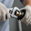 © Shafay - A macro photo of a plumber tightening a valve with a wrench