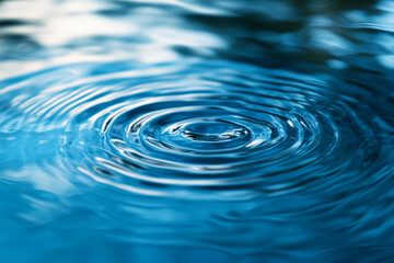 Fototapete - Close-up of concentric blue water ripples, creating a smooth and calming texture, symbolizing serenity, peace, and tranquility