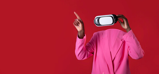 Poster - A user engages with a virtual reality headset, highlighting modern technology. The person is dressed in a bright pink jacket, creating a bold contrast against a red background, emphasizing innovation.