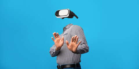 Poster - A person engages with advanced virtual reality technology, wearing a gadget that covers their eyes. Their hands are raised as if in interaction, set against a vibrant blue backdrop.