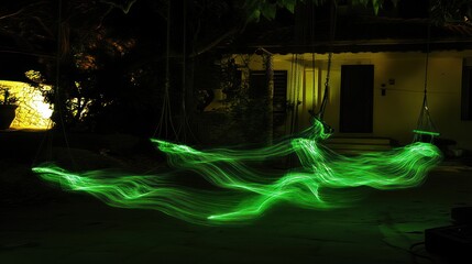 Aufkleber - Green light trails streak across a dark courtyard at night, near a building and hammocks.