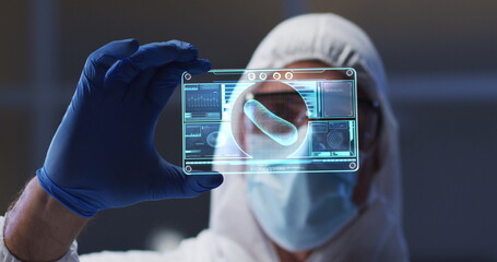 Poster - Image of scientist holding interactive screen with medical data processing