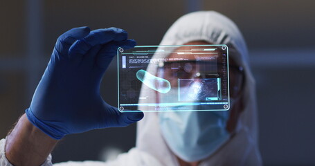Poster - Image of scientist holding interactive screen with medical data processing