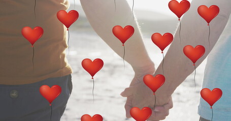 Poster - Image of red heart love balloons digital icons over couple holding hands on beach