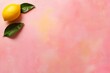 © Elena - A vibrant yellow lemon rests alongside a glossy green leaf on a pastel coral surface, highlighting freshness and a minimalist aesthetic with plenty of copy space