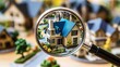© THUA - Magnifying glass zooming in on a miniature blue-roof house crisp and clear surrounded by other house models symbolizing real estate exploration.