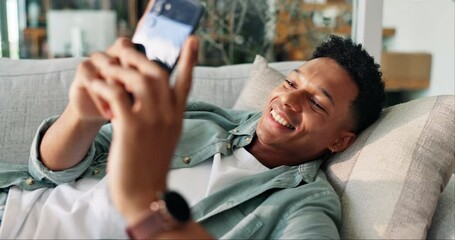 Poster - Dating app, phone and smile with man on sofa in living room of home for communication. Contact, relax and social media with happy person in apartment for connection, notification or online chat