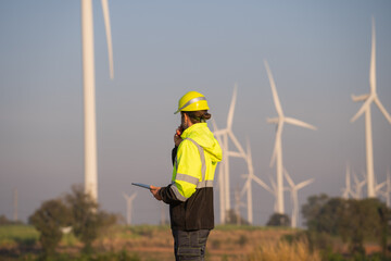 Aufkleber - Engineer man working with tablet at windmill farm Generating electricity clean energy. Wind turbine farm generator by alternative green energy.