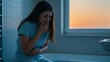 © Qbertstudio - Young adult Caucasian woman in bathroom with stomach pain, hand on mouth, Low-key lighting enhances the worried mood, suggesting health concerns or sensitivity,