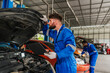 © kelvn - Team Auto mechanic are checking and repair maintenance auto engine