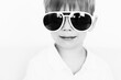 © kichigin19 - portrait of a boy in sunglasses, a child of 4-6 years old in large sunglasses on a white background