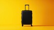 A sleek black hard-shell suitcase standing upright on a vibrant yellow background.