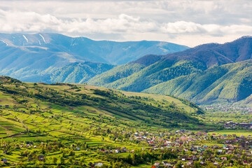 Wall Mural - mountainous countryside landscape with kolochava village in the valley. cloudy weather. rural fields