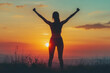 © Veronika - Woman on hilltop at sunset, silhouette against colorful sky, arms outstretched, embracing the beauty of nature.