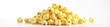 © DITSARAPHAN - A high pile of fresh, buttery pop corn against a blank white backdrop, cinema, treat, heap