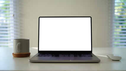 Aufkleber - Minimalist work desk featuring a laptop with a blank screen, a warm coffee cup on a coaster.