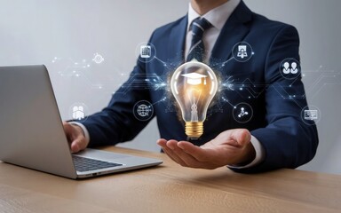 Poster - Igniting Ideas: A person in professional attire, skillfully holds a glowing lightbulb symbolizing knowledge, innovation, and new ideas while working on a laptop.