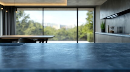 Poster - Modern kitchen interior with a sleek countertop, large windows revealing a lush outdoor view and minimalistic design