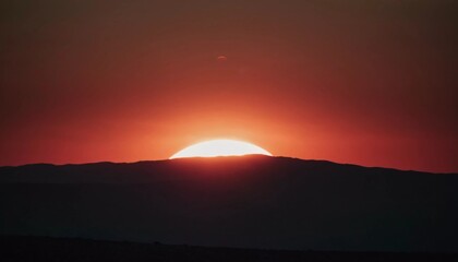 Poster - As the celestial orb gracefully descends beyond the horizon, a brilliant light bathes the rugged peaks, igniting the sky with rich tones of orange, red, and gold Generative AI