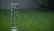 © Akstem - Rain gauge captures heavy rainfall. A wet and cloudy day outside.