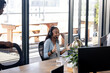 © Wavebreak Media - Young woman in office using headset, engaging in lively virtual meeting