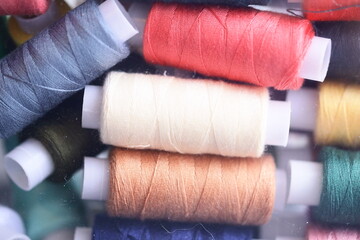 Poster - Close-up shot of multiple spools of thread, ideal for crafting or sewing projects.