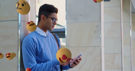Poster - Young man using smartphone outdoors surrounded by floating emojis, looking focused