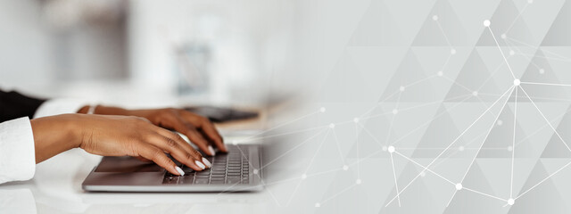 Poster - Closeup of african american businesswoman using laptop, typing on keyboard, writing email, sitting at desk in office, selective focus. Lady accountant writing financial report