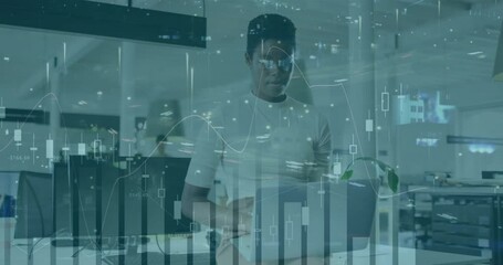 Poster - Businessman working on laptop with financial data charts overlay animation