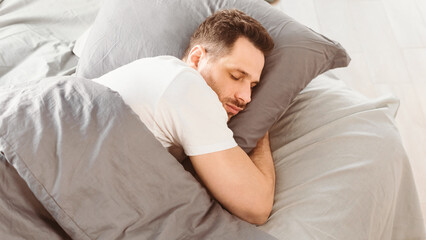 Aufkleber - Asleep Man Sleeping Hugging Pillow Lying In Comfortable Bed Resting In Bedroom At Home. Healthy Male Sleep, Recreation And Wellness, Napping Concept. Panorama