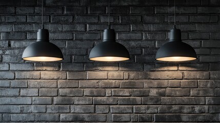Poster - Three modern illuminated pendant lights hanging above a dark brick wall, casting soft light and creating a stylish ambiance in an industrial space