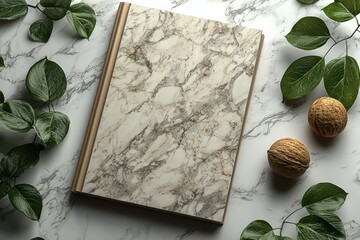 Aufkleber - Close-up of a textured marble book cover surrounded by greenery and walnuts on a marble surface
