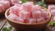 © Emile - a wooden bowl filled with cubes of double roasted turkish delight rests on a wooden surface the light background emphasizes the texture,inviting look of the sweets