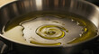 © aula - Olive Oil Sizzling in a Stainless Steel Pan Creating a Golden Spiral on a Stove Top