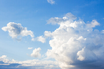Wall Mural - white cumulus clouds on a blue sky. beautiful nature background in afternoon light. sunny weather in