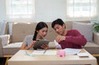 © itchaznong - Collaborative Financial Planning. A couple focused on setting financial goals and budgeting effectively.