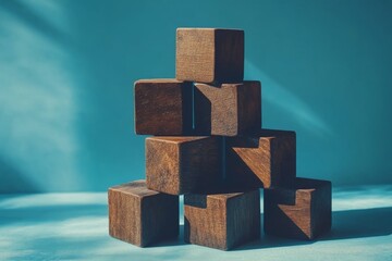 Poster - Wooden blocks stacked creatively against a blue background during daylight