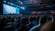 © Maksym - A large audience facing a brightly lit stage where the keynote speaker presents, digital screens on both sides showing global statistics and graphs, ambient light casting soft shad