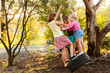 © Austockphoto - Friends playing together on tyre swing