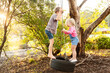 © Austockphoto - Young kids playing together on tire swing in backyard