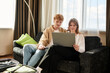 © LIGHTFIELD STUDIOS - Young couple enjoying quality time together while browsing in a cozy hotel room