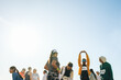 © Jacob Lund - Group of runners stretching before a marathon event on a sunny day