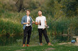 © prostooleh - Two men fishing near the river and drinking a beer