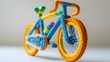 © Anastasiia - A colorful model bicycle made from plastic or flexible building materials, featuring vibrant orange, blue, and green details. Concept Colorful Model Bicycle, Plastic Building Materials