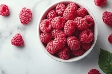 Aufkleber - Fresh raspberries in a white bowl on a marble countertop with scattered berries around