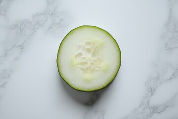 Poster - Sliced cucumber showcasing fresh green skin and light interior on a marble surface