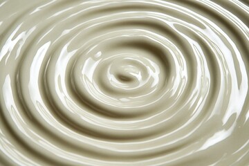 Aufkleber - Creamy texture of flowing liquid creating symmetrical ripples in a shallow container during daylight