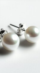 Poster - Elegant pearl earrings on a white surface capturing the luminous sheen and delicate jewelry design for refined style and timeless elegance