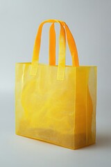 Poster - Vibrant Yellow Mesh Tote Bag on Clean Background Capturing Modern Style and Sustainable Shopping with Bright Light and Airy Composition for Stock Photography